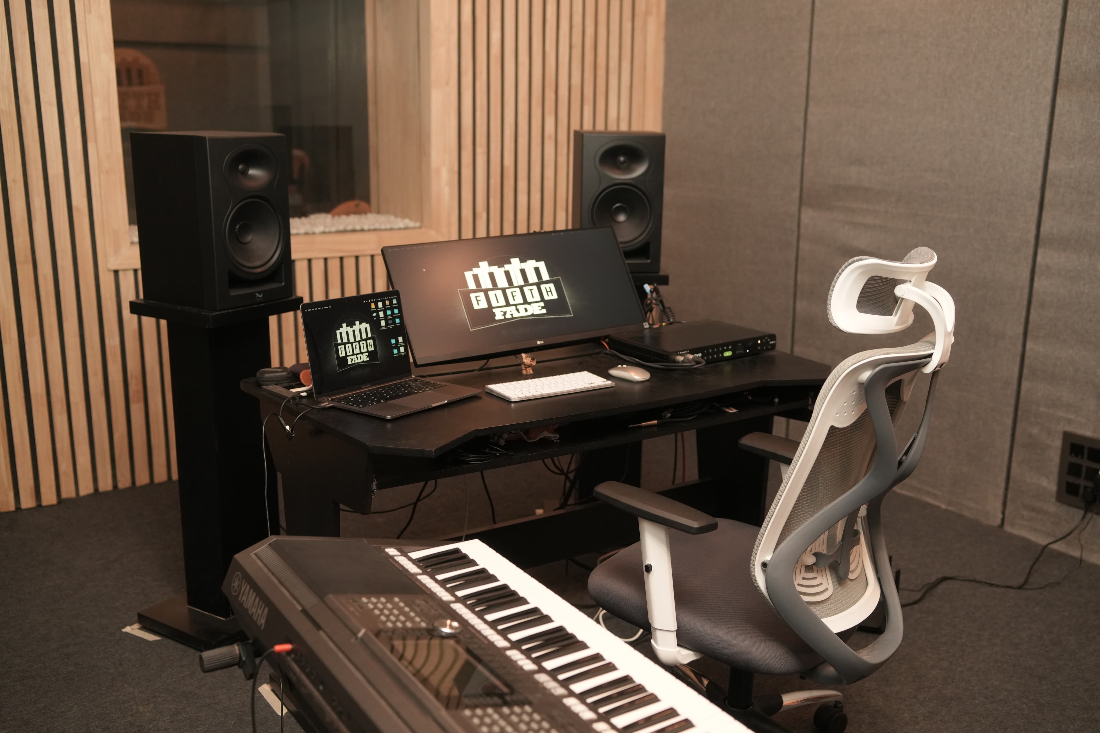 Control room facing vocal booth with Fifth Fade logo