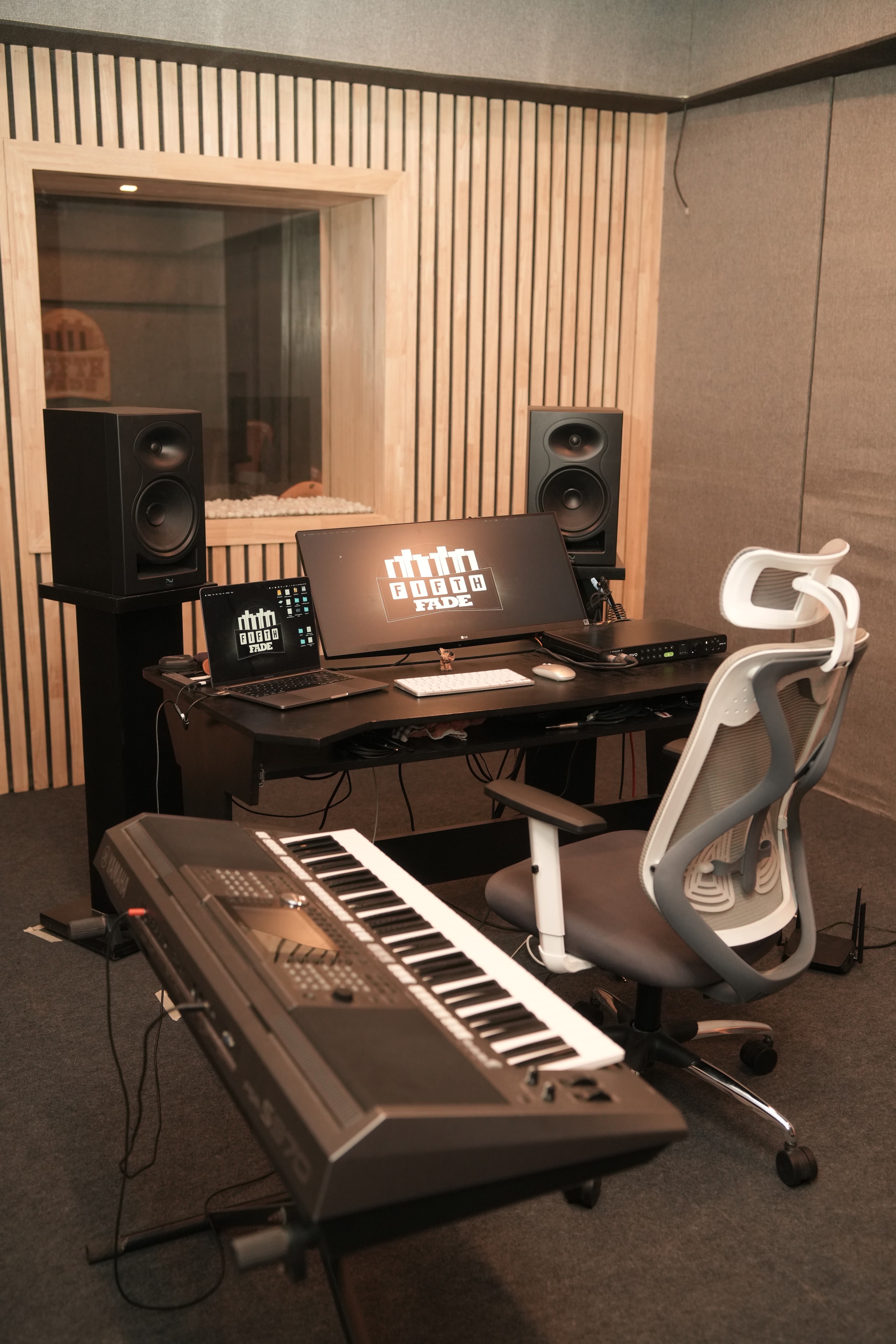 Control room facing vocal booth with Fifth Fade logo