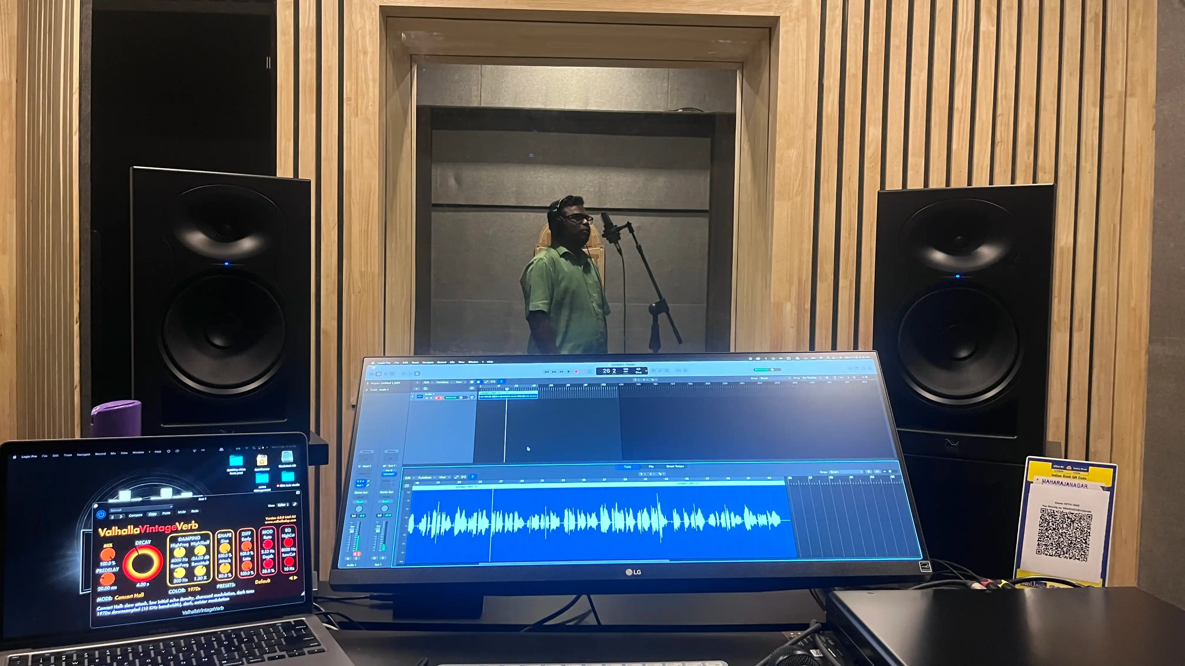 Engineer at DAW with vocalist recording in the booth