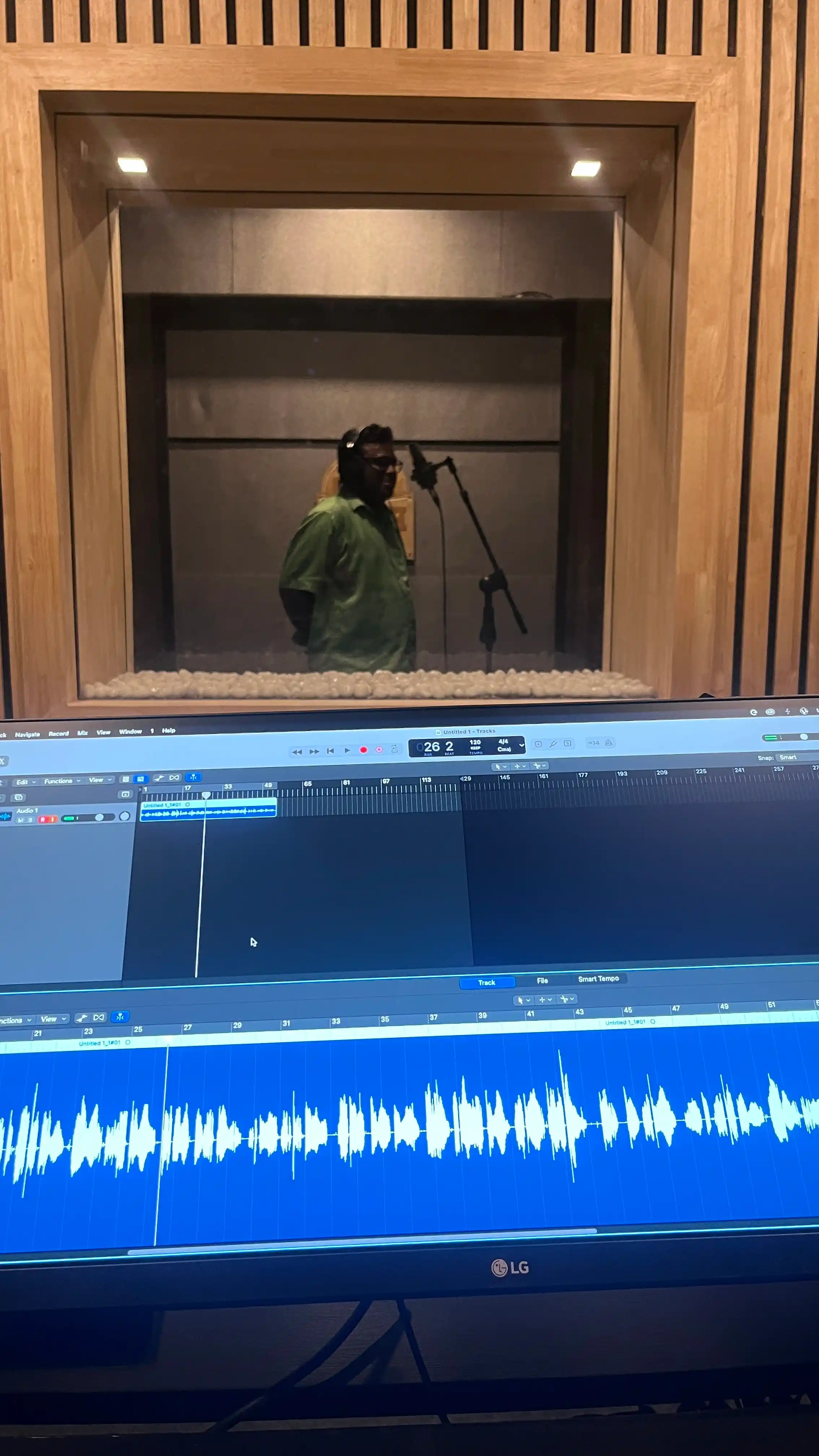 Engineer at DAW with vocalist recording in the booth